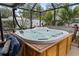 This screened-in patio features a large hot tub and privacy landscaping at 1350 Maple Sw St, Largo, FL 33770