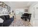 Cozy living room featuring a piano, gallery wall and comfortable seating at 1723 Virginia Willow Dr, Wesley Chapel, FL 33544