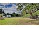 Large grassy backyard with chain link fence and mature trees at 18236 Ackerman Ave, Port Charlotte, FL 33948