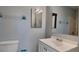 Bathroom with vanity, decorative mirror, and tub shower with tiled walls at 18236 Ackerman Ave, Port Charlotte, FL 33948
