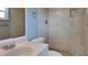 Bathroom featuring tiled shower with built in seat, vanity with sink, and toilet at 18236 Ackerman Ave, Port Charlotte, FL 33948