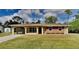 Charming single-story home featuring a covered carport and a well-maintained front yard at 18236 Ackerman Ave, Port Charlotte, FL 33948