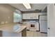 Functional kitchen featuring white cabinetry, quartz countertops, and stainless steel appliances at 18236 Ackerman Ave, Port Charlotte, FL 33948