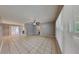 Spacious living area featuring neutral paint, large windows, and tile flooring throughout at 18236 Ackerman Ave, Port Charlotte, FL 33948