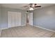 Bedroom with neutral paint, ceiling fan, tile flooring, and closet at 18236 Ackerman Ave, Port Charlotte, FL 33948