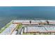 Aerial shot of complexes facing the water, with carports and well-manicured landscaping at 19029 Us Highway 19 N # 30H, Clearwater, FL 33764