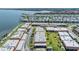 Aerial view features a waterfront complex with lush landscaping, parking, and water access at 19029 Us Highway 19 N # 30H, Clearwater, FL 33764