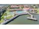 Scenic aerial view of community pool, tennis court, putting green, and waterfront access at 19029 Us Highway 19 N # 30H, Clearwater, FL 33764