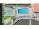 Aerial shot of a pool, shuffleboard, and water feature amenities, with a tile-roofed building nearby at 19029 Us Highway 19 N # 30H, Clearwater, FL 33764