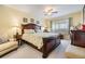 Well-lit bedroom featuring a large bed, soft carpet, and side chair at 19029 Us Highway 19 N # 30H, Clearwater, FL 33764