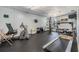 Well-equipped exercise room with treadmill, stationary bike, and multi-station workout machine at 19029 Us Highway 19 N # 30H, Clearwater, FL 33764
