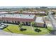 Charming exterior view of the townhome with a well-maintained lawn and mature palm trees at 19029 Us Highway 19 N # 30H, Clearwater, FL 33764