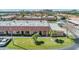 Charming exterior view of the townhome with a well-maintained lawn and mature palm trees at 19029 Us Highway 19 N # 30H, Clearwater, FL 33764