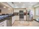 Beautiful, remodeled kitchen featuring stainless steel appliances, granite countertops, and stone floors at 19029 Us Highway 19 N # 30H, Clearwater, FL 33764