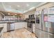 Spacious kitchen with stainless steel appliances, granite countertops, a breakfast bar, and an open floor plan at 19029 Us Highway 19 N # 30H, Clearwater, FL 33764