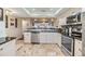 Open-concept kitchen featuring stainless steel appliances, granite countertops, breakfast bar and an open floor plan at 19029 Us Highway 19 N # 30H, Clearwater, FL 33764