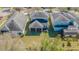 Aerial view of a house with a well-maintained backyard and a screened-in porch at 20326 Merry Oak Ave, Tampa, FL 33647