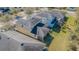 Aerial view of a house with a screened-in porch and a well-maintained backyard at 20326 Merry Oak Ave, Tampa, FL 33647