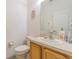 Bathroom featuring a light wood vanity, single sink, and a white toilet at 20326 Merry Oak Ave, Tampa, FL 33647