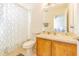 Full bathroom with a single sink vanity, a toilet, and a shower-tub combo at 20326 Merry Oak Ave, Tampa, FL 33647