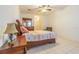 Cozy bedroom featuring neutral walls, tile flooring, and a ceiling fan for added comfort at 20326 Merry Oak Ave, Tampa, FL 33647