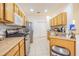Bright and airy kitchen featuring stainless steel appliances, light wood cabinets, and easy-to-clean tile floors at 20326 Merry Oak Ave, Tampa, FL 33647
