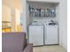 A laundry room with a Samsung washer and dryer and overhead shelving at 20326 Merry Oak Ave, Tampa, FL 33647