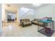 Open living area with tile floors, stairs, and comfortable seating for relaxation at 20326 Merry Oak Ave, Tampa, FL 33647