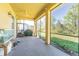 Relaxing screened patio offers a serene outdoor space, with views of the landscaped backyard and nearby houses at 20326 Merry Oak Ave, Tampa, FL 33647