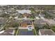 Beautiful aerial view of houses near a lake, featuring a backyard pool and fenced yard at 20849 Cedar Bluff Pl, Land O Lakes, FL 34638