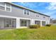 Rear exterior featuring a private screened in porch and manicured backyard at 2109 Laceflower Dr, Brandon, FL 33510