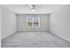 Spacious bedroom with plush carpet, ceiling fan and window at 2109 Laceflower Dr, Brandon, FL 33510