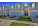 Two-story townhome featuring blue siding, well-manicured landscaping, and attached garages at 2109 Laceflower Dr, Brandon, FL 33510