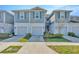 Attractive townhomes with blue siding, white trim, and nicely landscaped front yards at 2109 Laceflower Dr, Brandon, FL 33510