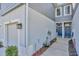 Side view of a townhome with a light gray exterior, showing the garage and entrance at 2109 Laceflower Dr, Brandon, FL 33510