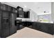 Contemporary kitchen with black appliances, tile floors, granite countertops, and an open layout at 2109 Laceflower Dr, Brandon, FL 33510