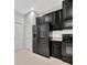 Modern kitchen featuring sleek, black appliances and granite countertops at 2109 Laceflower Dr, Brandon, FL 33510
