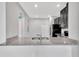 Open kitchen features granite countertops with a stainless steel sink and black appliances, offering functionality and style at 2109 Laceflower Dr, Brandon, FL 33510