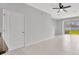 Bright living room features neutral tones, tile flooring, a ceiling fan, and sliding glass doors to the outdoor space at 2109 Laceflower Dr, Brandon, FL 33510