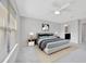 Bright main bedroom features a ceiling fan, large window, and ensuite bathroom at 2109 Laceflower Dr, Brandon, FL 33510