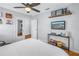 Cozy bedroom with a ceiling fan, hardwood floors, and a view of the backyard at 2145 8Th N Ave, St Petersburg, FL 33713