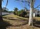 Landscaped backyard featuring lush greenery, mature trees, and privacy fencing at 2218 Egret Walk Ct, New Port Richey, FL 34655