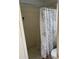 Bathroom with tiled shower stall, neutral walls, and patterned shower curtain at 2218 Egret Walk Ct, New Port Richey, FL 34655