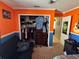 Bedroom with closet, wall art, orange walls, and blue trim at 2218 Egret Walk Ct, New Port Richey, FL 34655