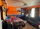 Cozy bedroom featuring a ceiling fan, personal decorations, and study space at 2218 Egret Walk Ct, New Port Richey, FL 34655