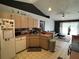 Open concept kitchen with stainless steel appliances and adjacent living area with natural light at 2218 Egret Walk Ct, New Port Richey, FL 34655
