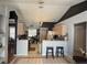 Bright kitchen with tile flooring, breakfast bar, modern appliances, and contrasting black accent wall at 2218 Egret Walk Ct, New Port Richey, FL 34655