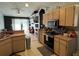 View of the kitchen with modern appliances, cabinetry, and a view into an open-concept living space at 2218 Egret Walk Ct, New Port Richey, FL 34655