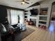 Stylish living area with tile flooring, built-in shelving, and a comfortable sectional sofa at 2218 Egret Walk Ct, New Port Richey, FL 34655