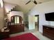 Bedroom with large windows, neutral walls, plus a dresser and mounted TV at 2218 Egret Walk Ct, New Port Richey, FL 34655